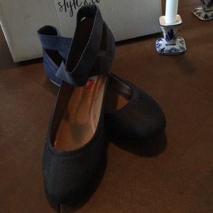Denim flats with crisscross ankle strap.